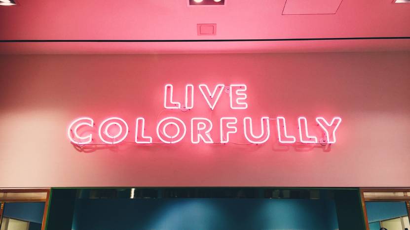 Pink neon sign with the words Live Colorfully